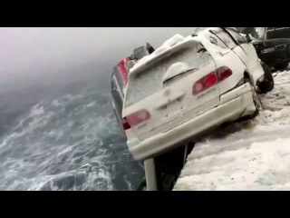 a terrible storm throws a car on a barge